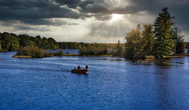 Fishermen in fishing boat on lake in Michigan 