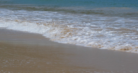 Sandy beach sea wave at ocean