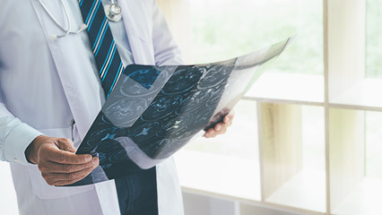 Patient listening intently to a male doctor explaining patient symptoms or asking a question as...