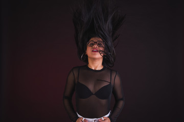 Obraz premium Young girl model posing in black background studio with black transparency t-shirt
