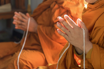 Buddhist monk praying hand in buddhism tradition ceremony.