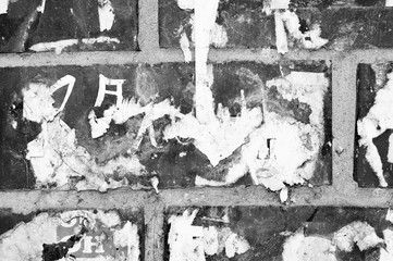 The brick wall is covered with scraps of paper for backgrounds