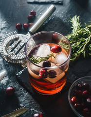 hamd crafted rosemary and cranberry cocktail on slate