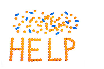 Prescription pills drugs medications antidepressant spell the word HELP with a scatter of tablets isolated on white background