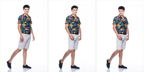 Young Caucasian Man in Summer tropical printed Polo Shirt black short stand and walk in smile happy action with using smart mobile phone, white background isolated, Full Length collage group concept
