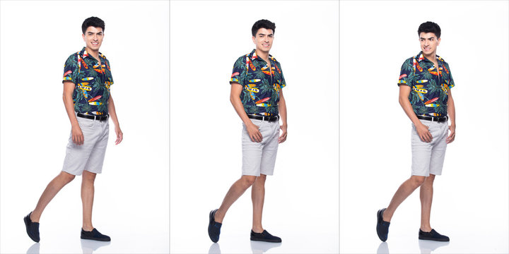Young Caucasian Man in Summer tropical printed Polo Shirt black short stand and walk in smile happy action with using smart mobile phone, white background isolated, Full Length collage group concept © Jade