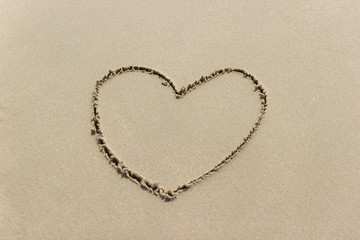 Fototapeta na wymiar heart symbol on a Sand at the Beach concept symbol of valentine day