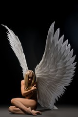 Nude woman with beautiful wings profile view