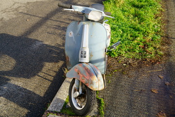 front of old rusty vintage vespa scooter