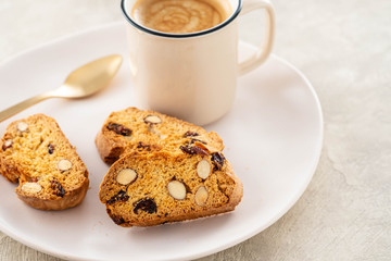 Italian biscotti cookies with a cup of coffee on a light background.