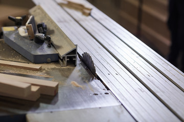 Close-up of lathe with saw cutting metal details in the plant