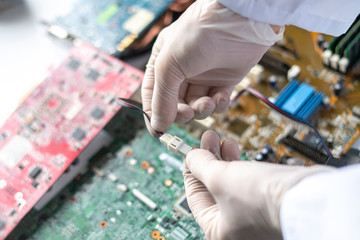 hands holding the electronic components working on the electronic research in laboratory,...
