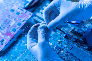 hands holding the electronic components working on the electronic research in laboratory,...