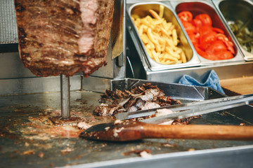 The process of preparing traditional Turkish fast food - grilled meat or shawarma or kebab