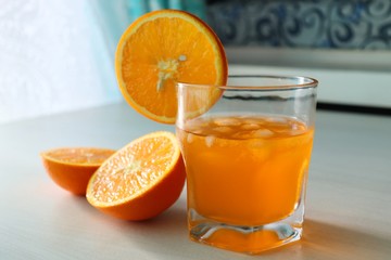 Orange fresh drink, glass of orange juice and ripe citrus fruits on white background