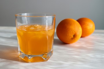 Orange fresh drink, glass of orange juice and ripe citrus fruits on white background