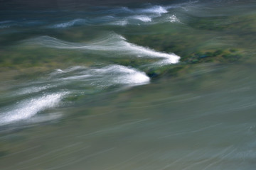 the sea coast in the afternoon with waves and splashes, the sea coast with stones.