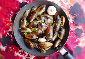 Overhead view of raw mussels with ingredients