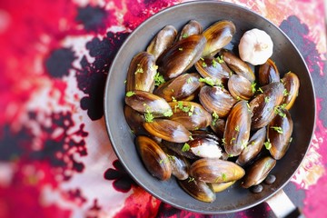 Overhead view of raw mussels with ingredients