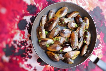 Overhead view of raw mussels with ingredients