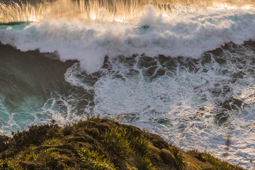 waves crashing on the cliff wall