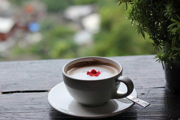 coffee in the morning, cup of cappuccino on wood table in cafe or coffeeshop.