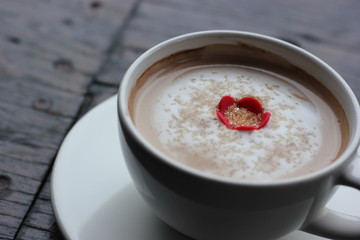 coffee in the morning, cup of cappuccino on wood table in cafe or coffeeshop.