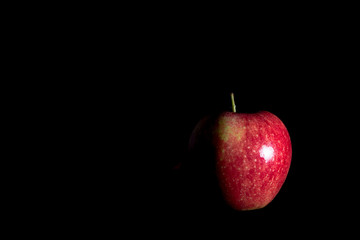 Delicious fresh red apple on black background