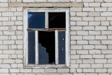 Broken windows of a brick house
