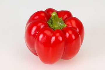 Ripe red bell pepper isolated on white