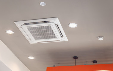Modern ceiling mounted cassette type air conditioning system in coffee shop