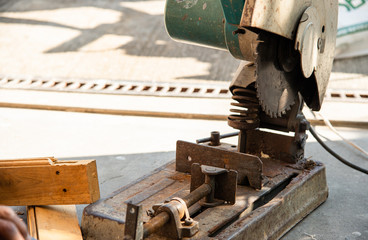 worker cutting wood with grinder