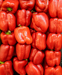 red bell peppers in a pile ready for sale.