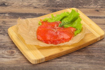 Sliced salmon fillet served rosemary