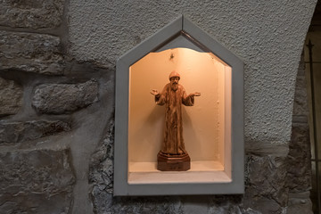 Obraz premium Wooden statuette stands in a niche behind glass in the Milk Grotto Church in Bethlehem in Palestine