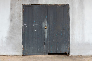 Black wood door and cemen wall,  the rusty lock with wood door, Old lock close home door.