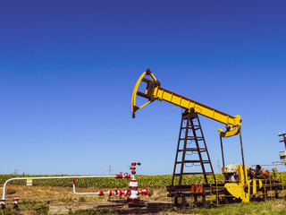 Fototapeta na wymiar Pumping unit as the oil pump installed on a well