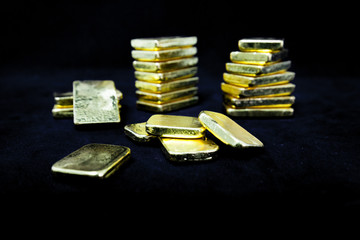 Investment concept of Several pile of gold bars in dark , Fine gold ingot ,Isolated on black...