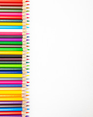 Colour pencils on white background close up