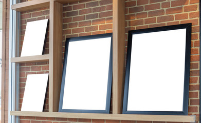 Mockup of Blank photo frames display on the shelf in coffee shop for your design
