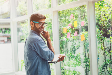 Smart business man thinking after looked at sticky note message