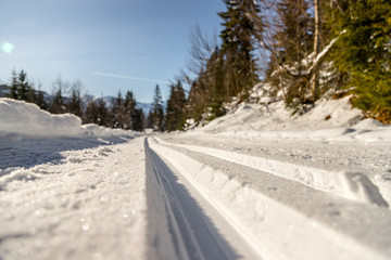 Cross-country skiing in Austria, Hinterthal: Slope, fresh white powder snow and mountains, blurry background