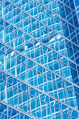 Reflection in blue glass wall of an modern office building