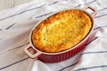 Homemade Cheese Corn Pudding Casserole on cloth, low angle view. Close-up.