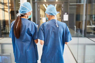 Two nurses in blue surgical clothes