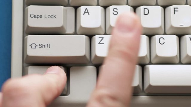 Male finger pushes CTRL + C button on white keyboard. Slow motion and macro view