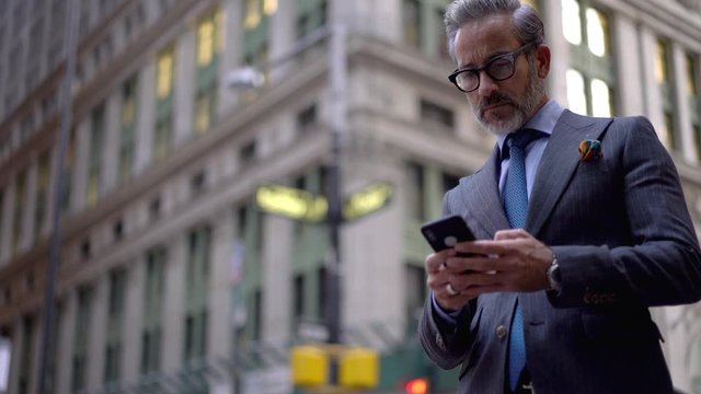 Confident male entrepreneur checking news about digital marketing using 4g wireless for browsing celebrating online win in partners deal, happy successful man in eyewear received good info