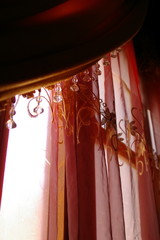 Exotic, beaded red sheer curtains.