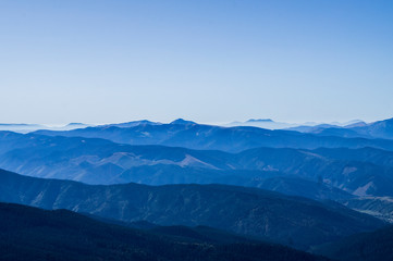Mountain clean landscape for the background of the website landing page or booklet. Rocks and hills far in the horizon. Colored sky.