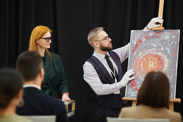 Business people presenting new art to other people at presentation